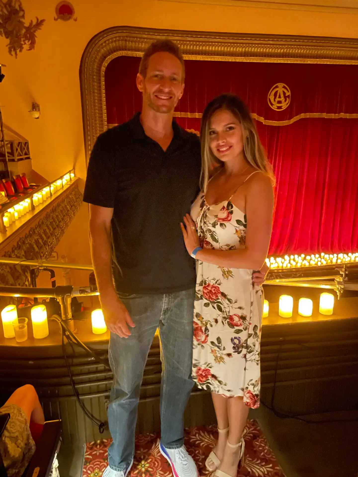 Rob and Veronica dressed up at a candlelit theatre