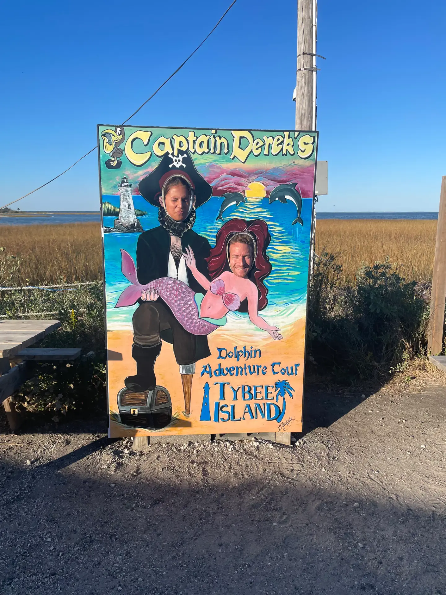Rob and Veronica behind a painted photo board on Tybee Island
