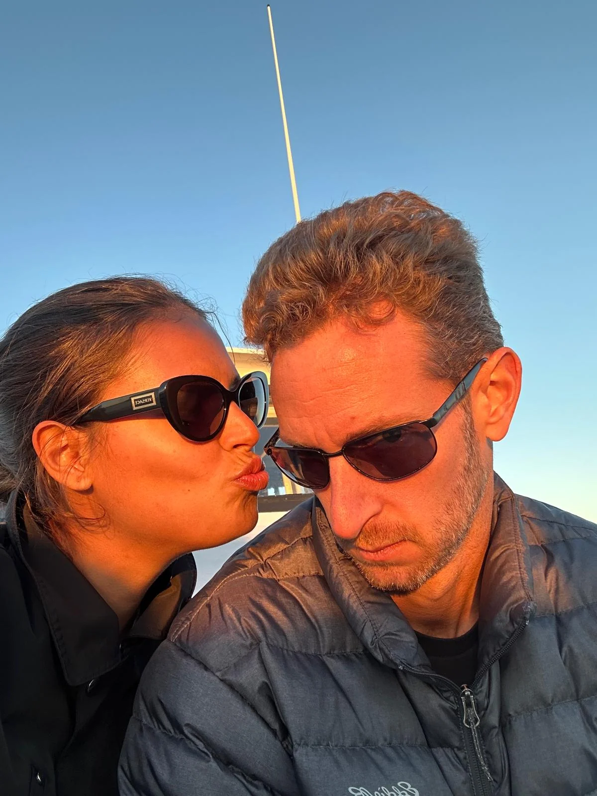 Rob and Veronica in sunglasses at golden hour on the water
